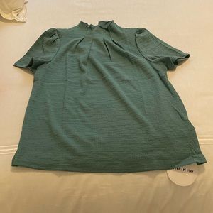Green ruffle neck shirt